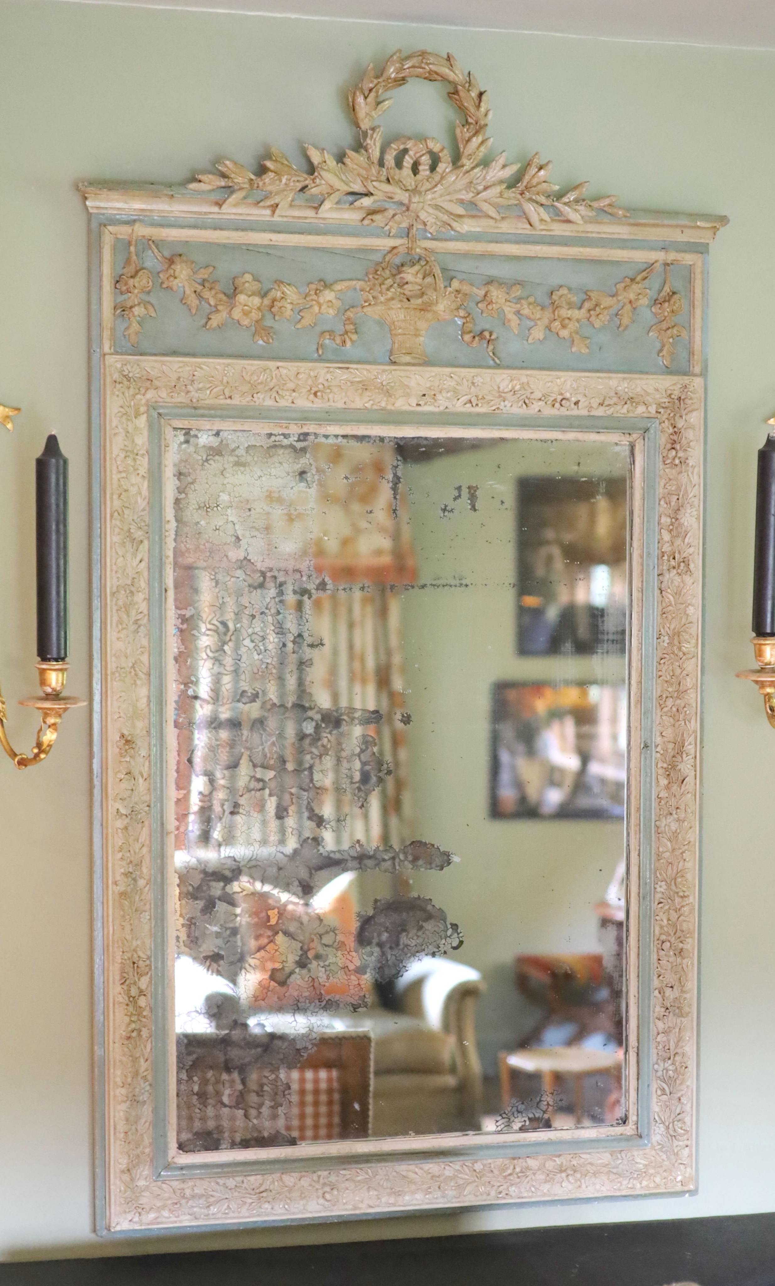 A late 19th century French blue and white painted gesso wall mirror, with laurel and floral basket frieze over a rectangular plate, width 76cm height 134cm